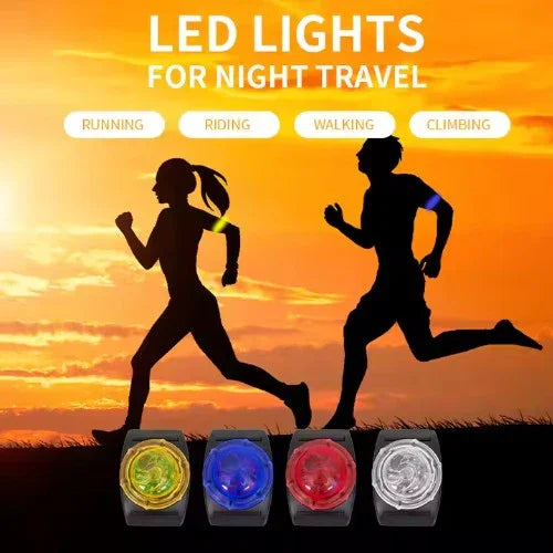 Silhouettes of a man and woman running with LED lights for night travel on an orange sky background.