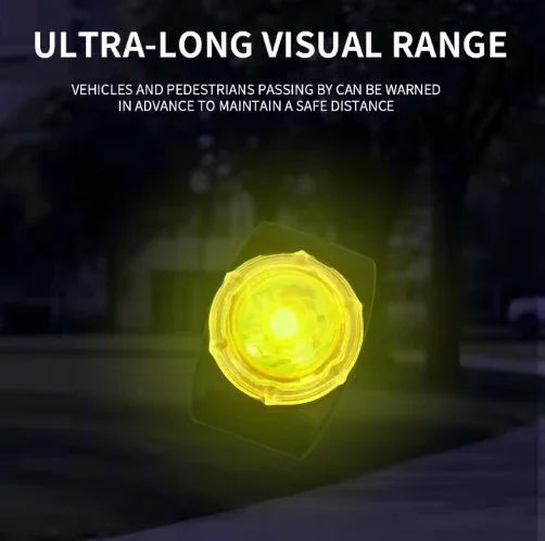Yellow warning light on a dark background with text about ultra-long visual range.