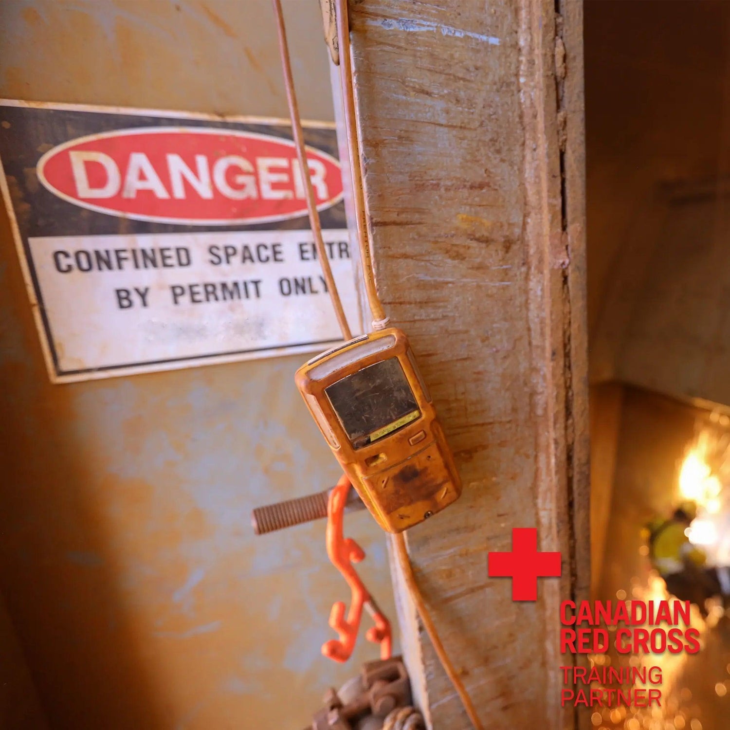 A warning sign and a device attached to a wall.