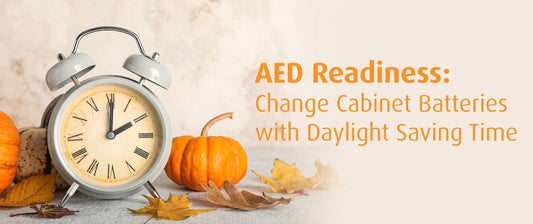 A clock nestled among pumpkins and vibrant autumn leaves, capturing the essence of the fall season with text AED Readiness: Change Cabinet Batteries with Daylight Saving Time.