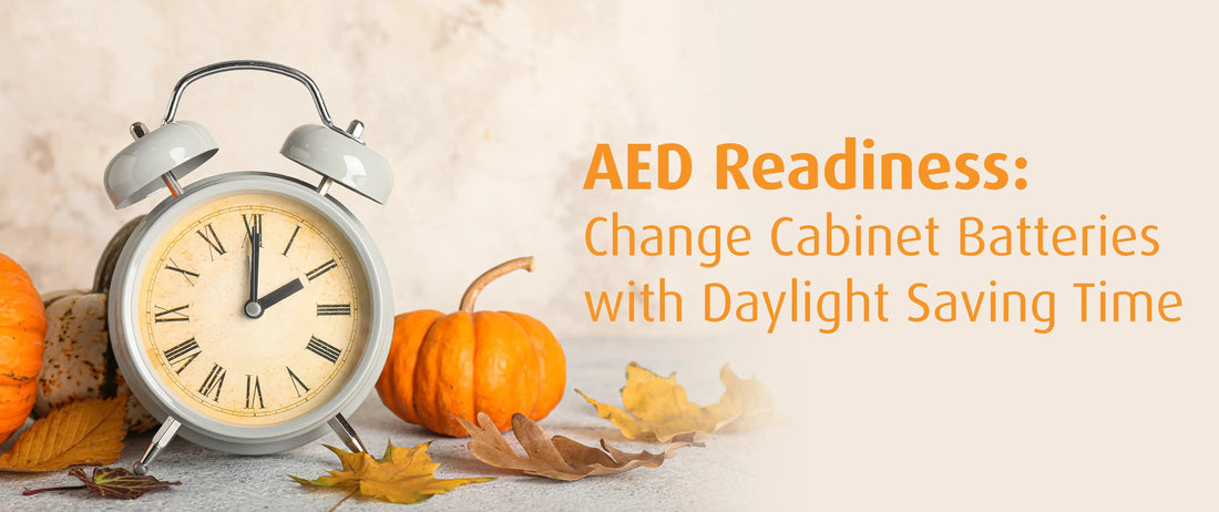 A clock nestled among pumpkins and vibrant autumn leaves, capturing the essence of the fall season with text AED Readiness: Change Cabinet Batteries with Daylight Saving Time.
