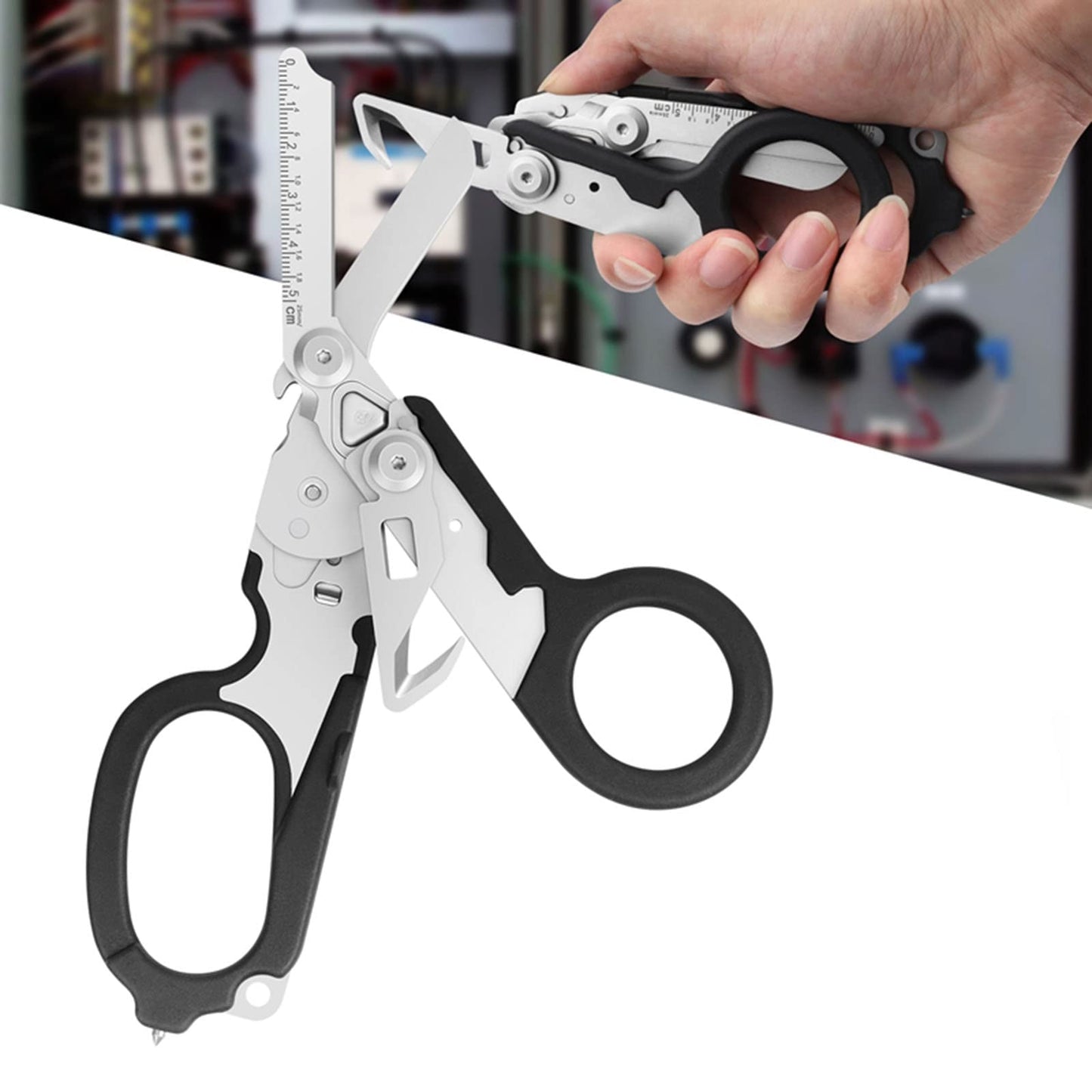 Multifunctional tool with scissors and pliers held by a hand on a blurred background