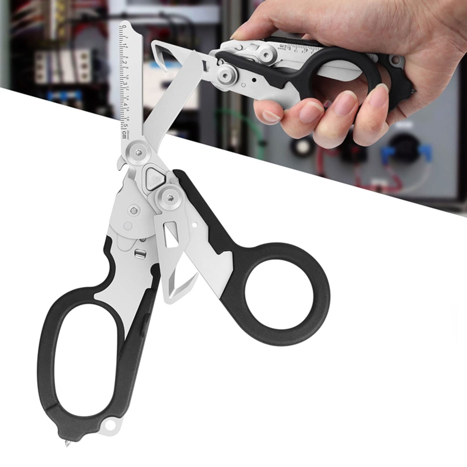Multifunctional tool with scissors and pliers held by a hand on a blurred background