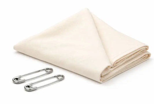 Triangular bandage folded with two safety pins included, used for arm slings, pressure dressings, and first aid immobilization.