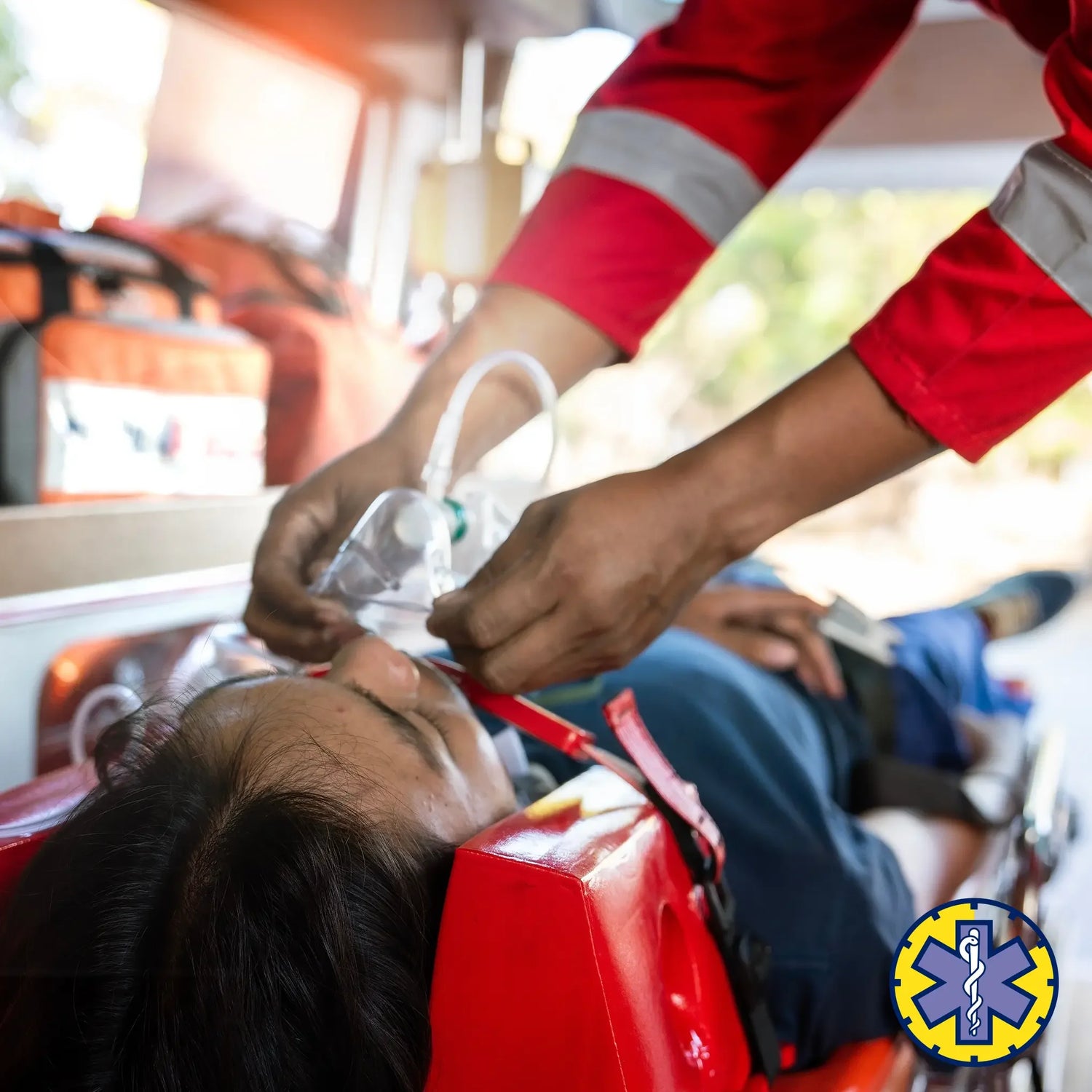Person receiving medical treatment in an ambulance with a focus on the hands and equipment.