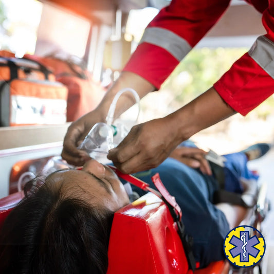 Person receiving medical treatment in an ambulance with a focus on the hands and equipment.